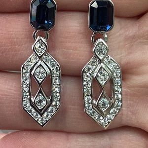 Elegant blue and clear crystal dangle earrings .